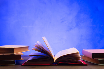 Wisdom and education concept.Book on the table, love reading. Retro neon light 90s