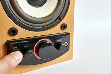 Fototapeta premium The man turns on the speaker by pressing the power button.