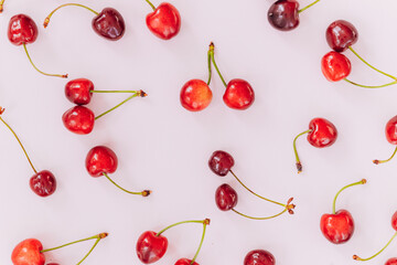 Cherry pattern. Flat lay of cherries on a pink background.Top view