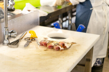 Fresh fish cut and cleaned on a fishmonger's table. Utensils to cut the fish and clean it. High quality photo