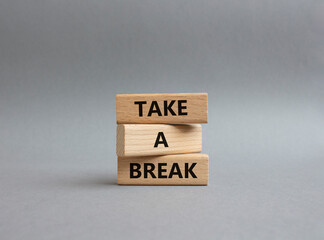 Take a break symbol. Concept words 'Take a break' on wooden blocks. Beautiful grey background. Business and Take a break concept. Copy space.