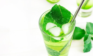 selective focus. refreshing detox drink with mint ginger and lemon. Cold mojito cocktail. A mint soft drink is healthy. Fresh mint, lime slices in cold water. High quality photo