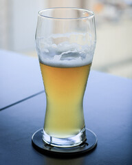 glass of beer on blue