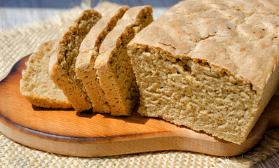 Oatmeal bread on a wooden board.