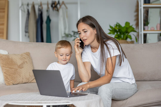 mom and son at home in the living room. parenting and business for a young European mom. A woman is working on a laptop and playing with her son. remote work, online business online. single mother