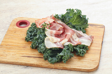 Raw pork bacon over board