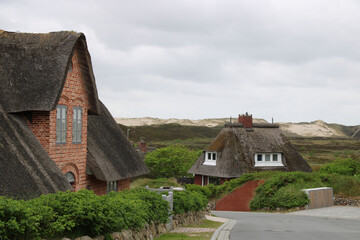 Fototapeta na wymiar Thatched-roof cottages on Sylt, Germany