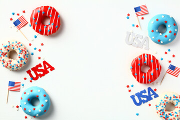 Flat lay donuts in colors of American flag and decorations isolated on white background. Happy Independence Day, Labor day, Presidents Day in US concept.