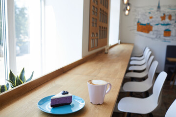 cappuccino or coffee with dessert stands on a table in a cafe