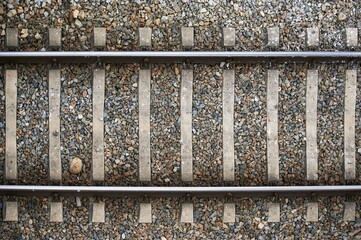 Aerial and detailed view of the train tracks built in metal and with stones around to use as a background
