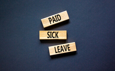 Paid sick leave symbol. Concept words Paid sick leave on wooden blocks. Beautiful black table black...