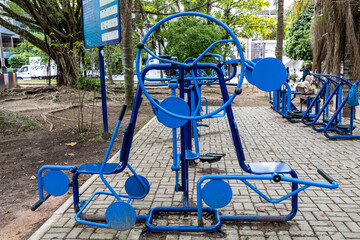 Metal exercise machines (sports) for the elderly in a park in Brazil. Leg trainers. Hand trainers....