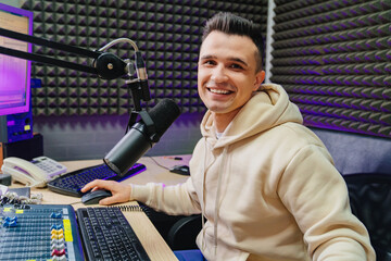 cheery radio host broadcasts live reads news on computer screen.