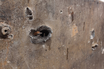 Bullet holes in Rusty russian tank burned by the Ukrainian military during Russian invasion of...