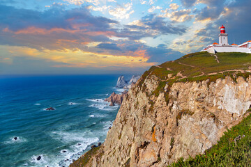 Fototapeta na wymiar Scenic view of the Atlantic Ocean and rocky shores at Cape Roca in Portugal. The Cabo da Roca lighthouse at the top of Cape Roca. Municipality of Sintra, Lisbon district, Portugal