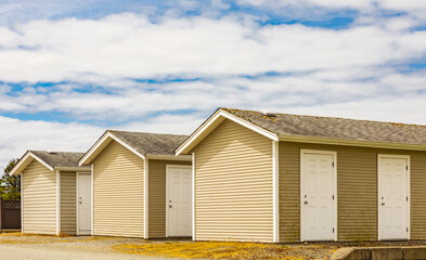 Modern cabins in holiday park. Cabins or houses on cloudy sky in the background