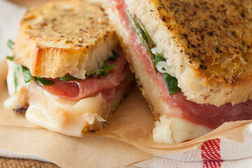 A gooey, Italian mozzarella and salami grilled cheese with a Parmesan toasted Italian bread