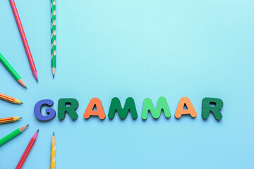 Word GRAMMAR with pencils on blue background