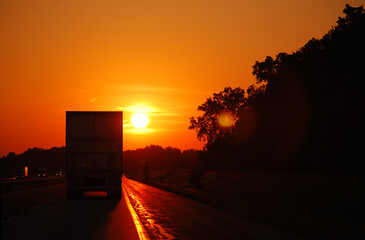 In the Midwest, USA. A semi truck on the highway as the sun is setting.