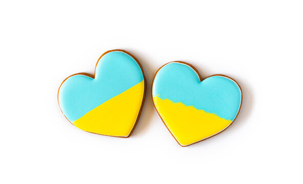 Two Heart shape ukrainian colours blue and yellow national flag gingerbread candies on white background.