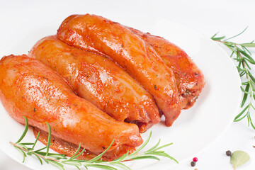 Marinated Chicken Breast with spices and rosemary. Raw meat in the marinade. Sottilissime raw fillet with spices and rosemary for grilling top view