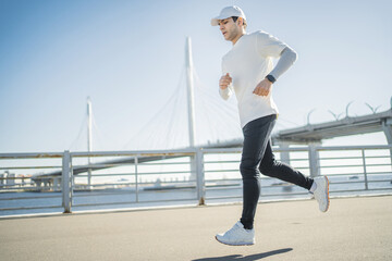 Fototapeta premium Athlete running outside active training, smart sports watch on hand