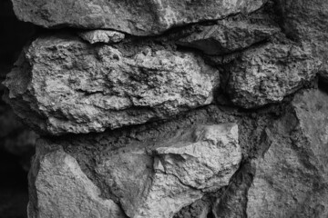 Brick Silver Wall. Rock background. Rock texture. Black texture. Dark Stone background. Rock pile. Paint spots. Rock surface with cracks. Grunge Rough structure. Abstract texture.