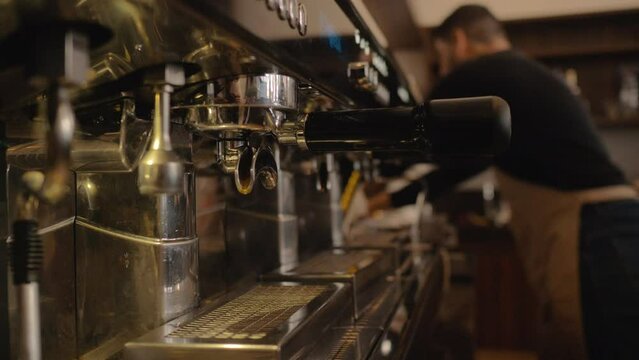 Barista preparing espresso and cappuccino in modern coffee shop