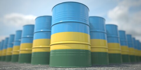 Flag of Rwanda on the barrels or steel drums. Chemical or oil industry related 3D rendering