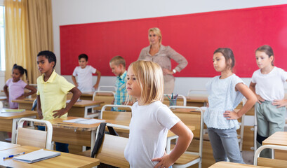 Fototapeta na wymiar Gymnastics in the classroom in elementary school