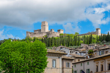 Fototapeta na wymiar Panorama of Assisi (Italy, Umbria region), taken from the surrounding countryside. Ancient medieval city, is world famous as birthplace of St. Francis, Italy's christian Patron.