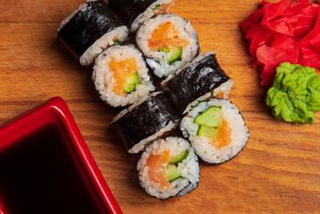 Japanese cuisine - roll set on wooden background.