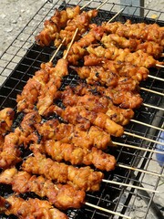 close up chicken grilling on stove