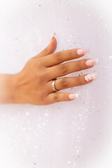 the bride's hands on her dress