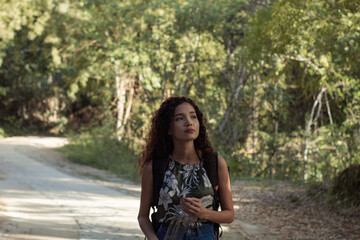 Fototapeta na wymiar girl on a walk through the forest while enjoying nature and drinking water