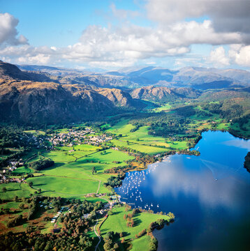 North over Coniston Lake, Coniston village and Yewdale Fells to Helvellyn in the Lake District National Park, Cumbria, England.
