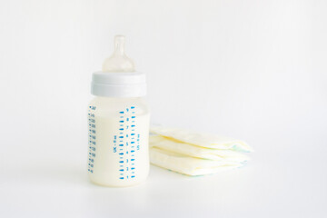 Stock of breast milk with milk bottles on white background.