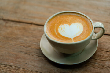 cup of cappuccino on wooden background.