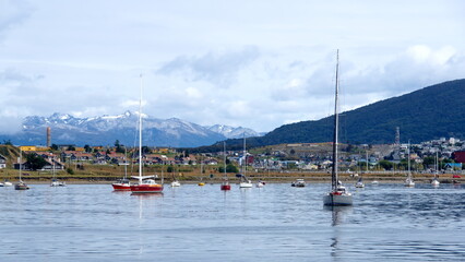 Sailboats in the harbor in Ushuaia, Argentina, with the Martial Mountains in the background