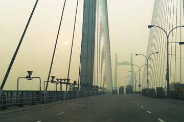 Obraz premium Vidyasagar Setu (Bridge) over river Ganges, 2nd Hooghly Bridge in Kolkata,West Bengal,India. Shot in winter morning. Connects Howrah and Kolkata, Longest Cable - stayed bridge in India.