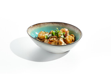 Pan asian food - udon with prawn, chicken wok on white background. Noodle with chicken and prawn in ceramic bowl. Indonesian wok with udon noodles. Spicy thai dish from noodle with shrimp and chicken.