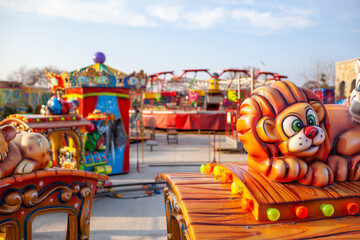 Children's rides and carousels are closed and empty. Joy and entertainment for children. Bright carousels and carriages for transporting children are empty. Carousels are waiting for children.