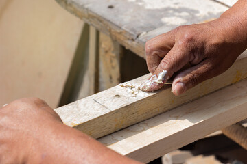 man working in his workshop with wood