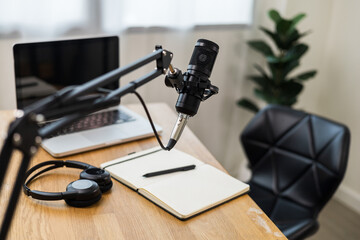 Condenser microphone in recording home studio. Content creator working with laptop host streaming radio podcast interview conversation at home broadcast studio recording voice over radio