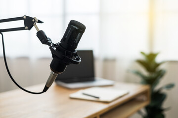 Condenser microphone in recording home studio. Content creator working with laptop host streaming radio podcast interview conversation at home broadcast studio recording voice over radio