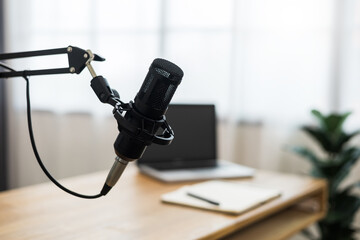Condenser microphone in recording home studio. Content creator working with laptop host streaming radio podcast interview conversation at home broadcast studio recording voice over radio