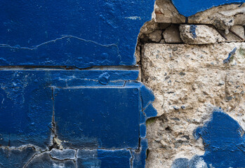 The blue plaster wall shattered from the impact.