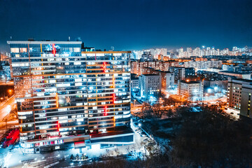 Fototapeta premium Top view of the night modern city. Bright lights of the night streets. Ekaterinburg. Russia
