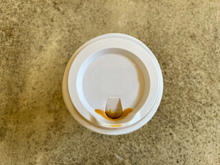 Coffee cup with lid and coffee stains