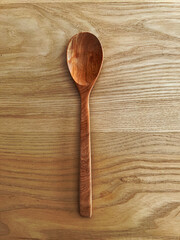 big wooden spoon on wooden background